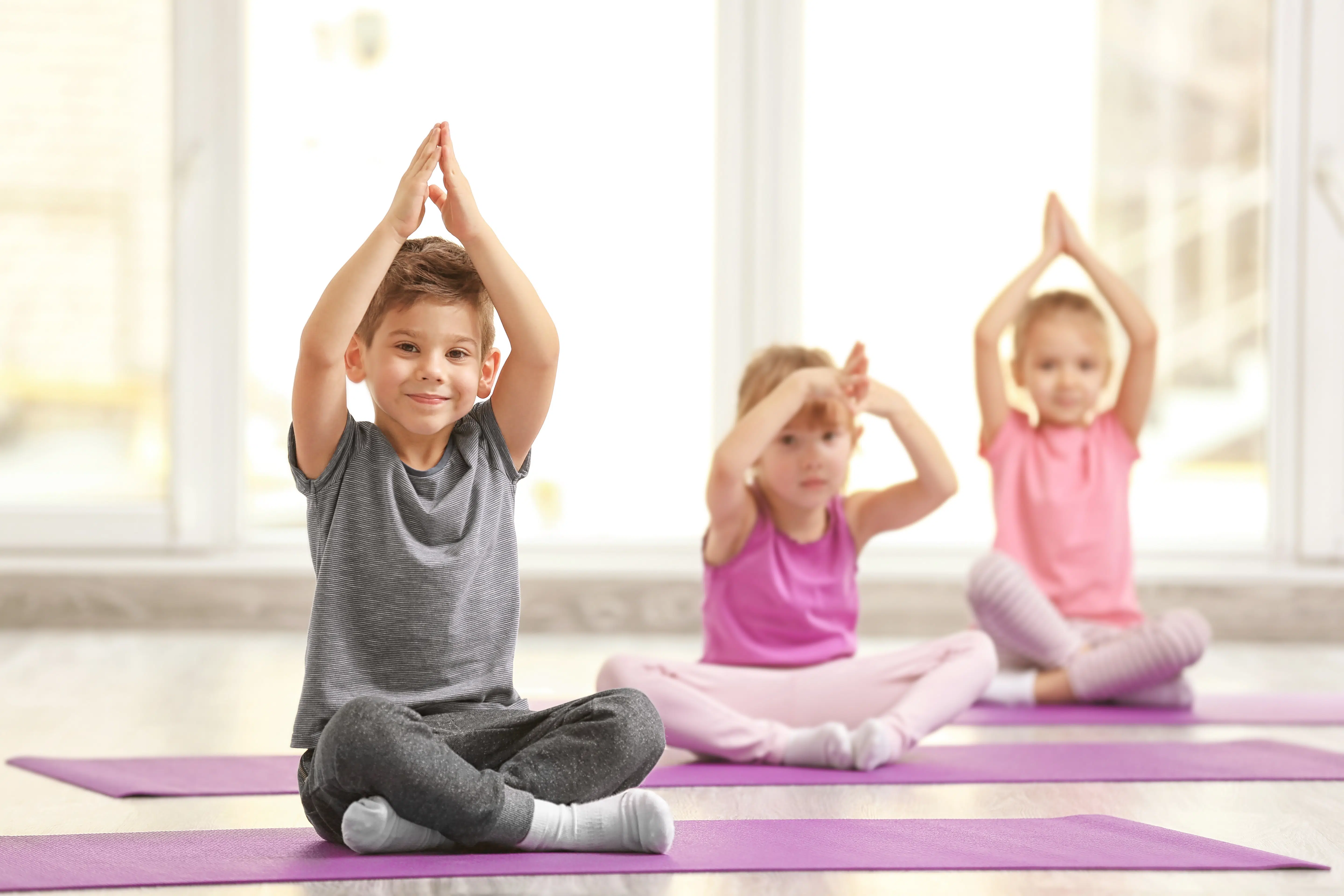 Group of children doing yoga exercises