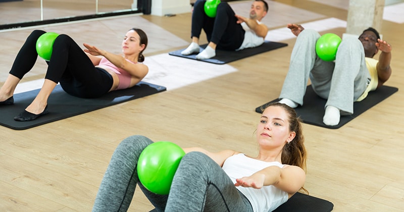 Group of people on mats in pilates class