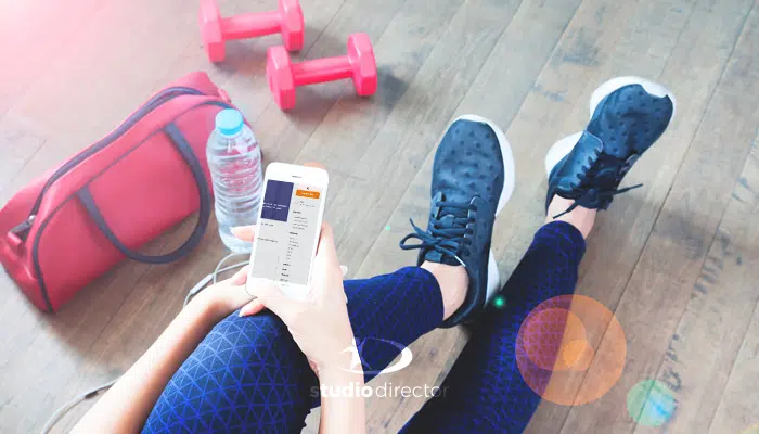 a person looking at their phone at the gym