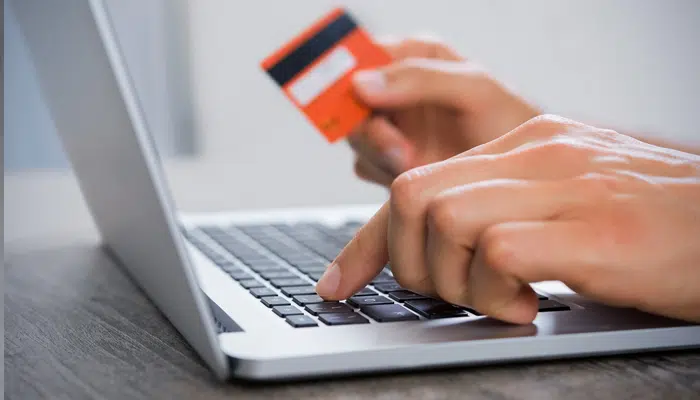 a person using a credit card on a computer