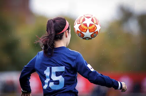 a young woman playing soccer