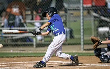 a young boy swinging a bseball bat