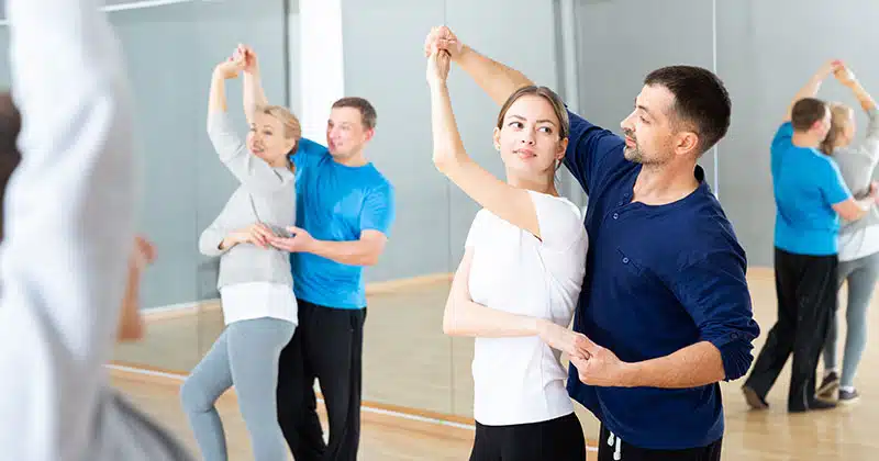 Two couples dancing in dance studio