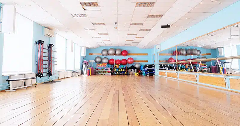 Wide shot of dance studio with fitness equipment