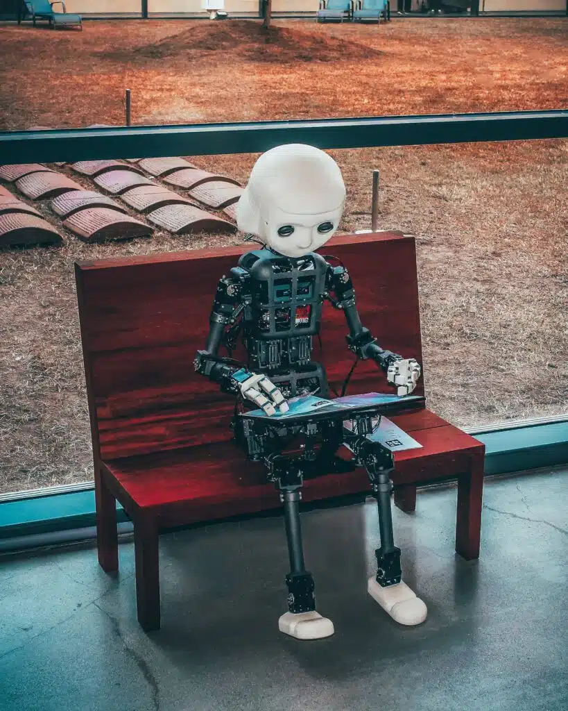 child size robot sitting on a bench
