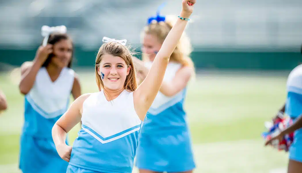 a cheer leader with their hand in the air