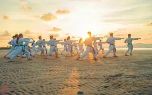 martial arts students on a beach
